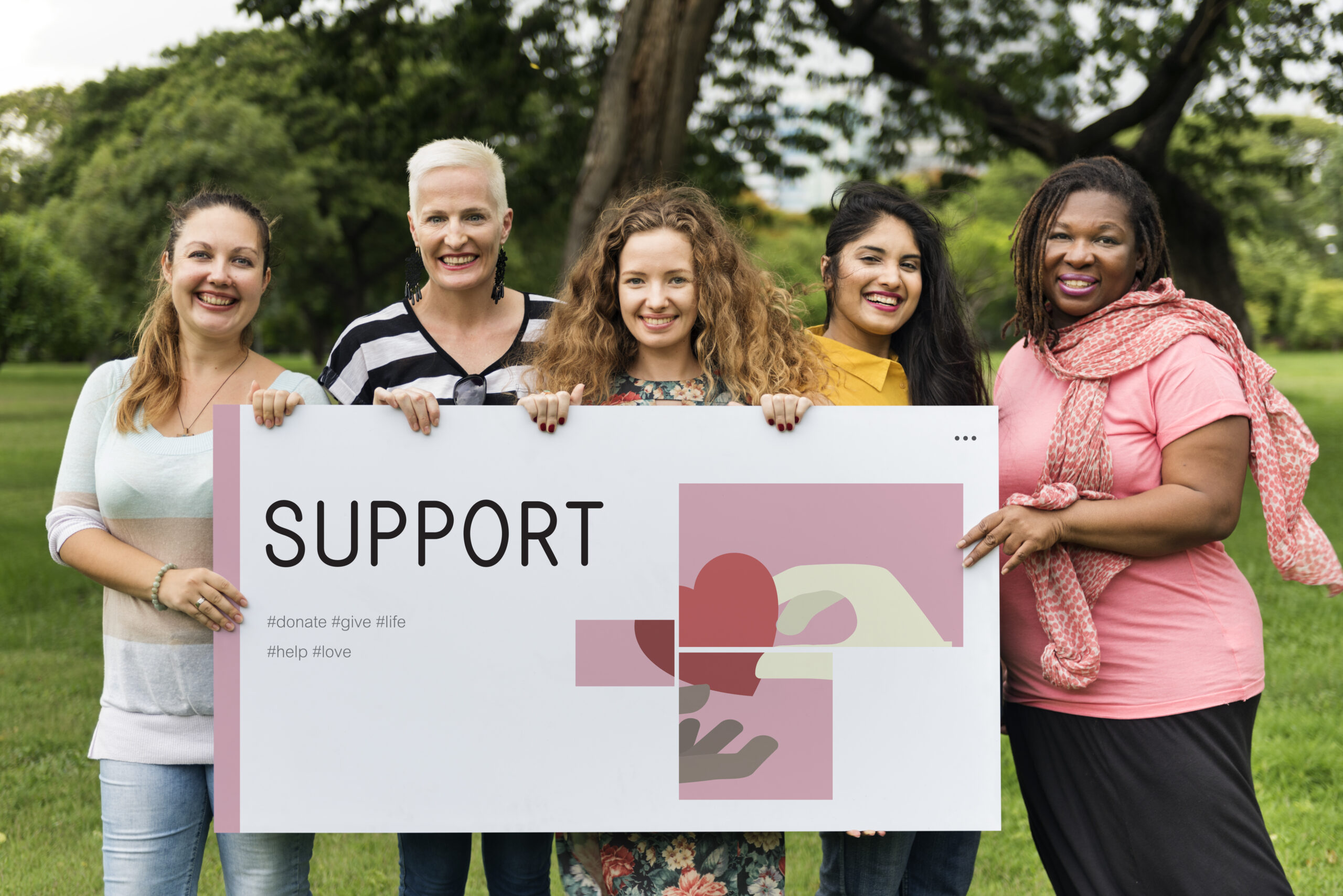 Group of women holding banner of charity donations campaign
